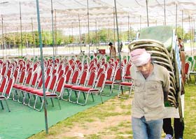 A worker places chairs for the March 29 CPI rally at the Parade Ground in Sector 17, Chandigarh, on Monday. 