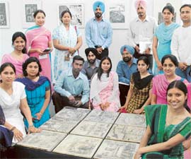 Students of Fine Arts Department of Punjabi University, Patiala, with their work being displayed at the Museum of Fine Arts, Panjab University, Chandigarh, on Monday. 