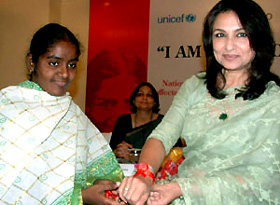 Ms Kaushalya, Secretary of Positive Womens Network of India, tying a ribbon over the hand of film personality Sharmila Tagore, during a function on HIV/AIDS in the Capital on Monday