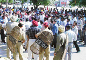 Fruit and vegetable sellers protest outside the Mandi Board office in Grain Market