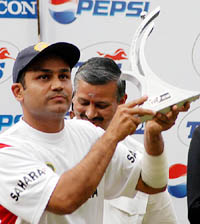 Virender Sehwag poses with the Man of the Series trophy