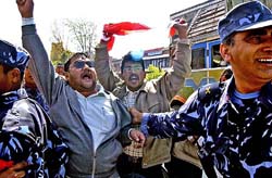 The police detains protesters during a demonstration against King Gyanendra outside government offices in Kathmandu on Monday. 