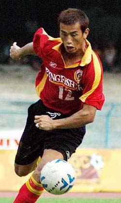 East Bengal striker Bhaichung Bhutia on way to scoring a goal after beating defender N Pradeep of State Bank of Travancore during the NFL match in Kolkata