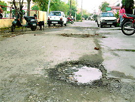 Pot-holed roads and garbage strewn around the locality make living conditions inhospitable