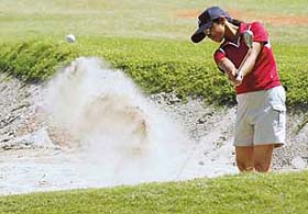 Preetinder Kaur attempts a bunker shot on 18th hole during 13th Chandigarh Open Ladies Amateur golf championship at the Chandigarh Golf Club