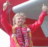 Virgin airlines flamboyant Chairman Richard Branson on the wing of his Airbus 340 along with his crew members on arrival at the Chhatrapati Shivaji International Airport in Mumbai on Thursday.