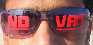 A trader in Amritsar wears a goggle with slogan NO VAT on Thursday.