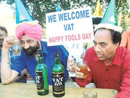 Satirists Jaspal Bhatti and Vinod Sharma celebrate 'Fools Day' by linking it with the implementation of VAT at a mock drinking place in Chandigarh on Thursday.