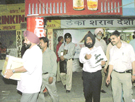 People buy liquor in bulk because of cheap prices in Chandigarh on Thursday.