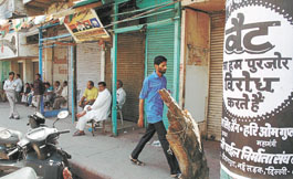 Traders sitting in front of their shops as they continue protest against the proposed implementation of VAT at Sadar Bazar in the Capital on Thursday.