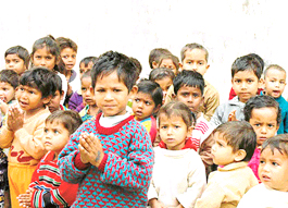 Listless children stand against the dilapidated wall of an anganwari centre in Sector 41, Chandigarh.  