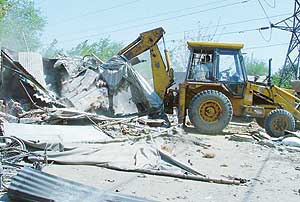 A bulldozer razes encroachments on the GT Road in Ludhiana on Saturday.