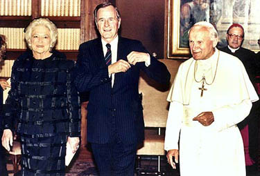 The then US President George Bush and First Lady Barbara Bush walk with Pope John Paul II after their meeting in the Vatican library, on May 27, 1989