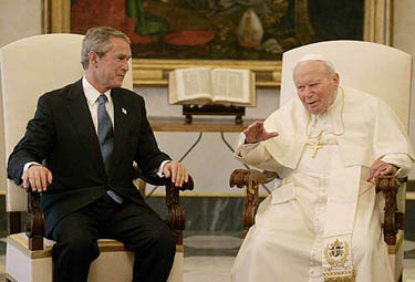 US President George W. Bush listens to Pope John Paul II at the Vatican on June 4, 2004.