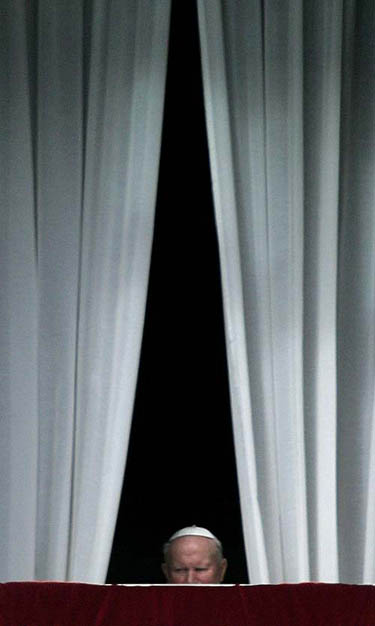 Pope John Paul II leaves the window of his private apartments at the end of the Angelus prayer in Saint Peter's Square at the Vatican on February 13.