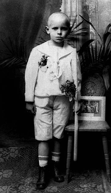 Pope John Paul II poses with a candle after receiving his First Communion in his home archidiocese of Krakow, Poland, in this undated file photograph