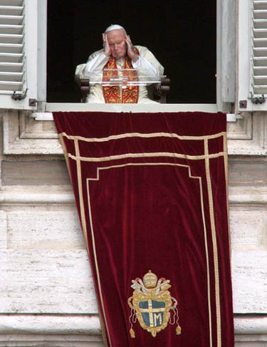 Pope John Paul II puts his hands to his head at his apartment overlooking the Vatican's St. Peter's square on March 27. An ailing Pope John Paul appeared at his window to bless the faithful on Easter Sunday but in a dramatic episode that brought tears to the eyes of many people, he failed in his attempt to speak. Aides had brought a microphone to the Pope's mouth. He tried to speak. He made a few sounds but was unable to pronounce any words. The aides then removed the microphone