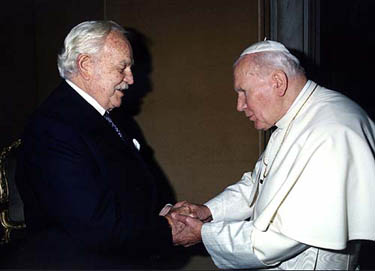 Prince Rainier of Monaco (L) is greeted by Pope John Paul II during their private meeting at the Vatican in this December 19, 1997 file photo. 