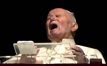Pope John Paul II grimaces as he appears at the window of his private apartments at the Vatican on March 30