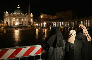 Nuns pray for the health of the Pope, in front of Saint Peter's Basilica at the Vatican on March 31.