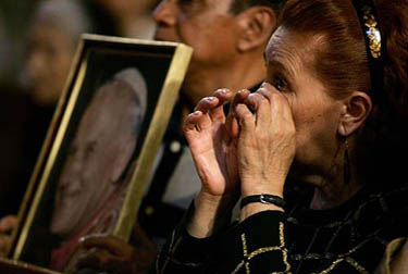 A Mexican worshiper wipes away a tear during a mass to pray for Pope John Paul II's health at Mexico City cathedral, on March 31