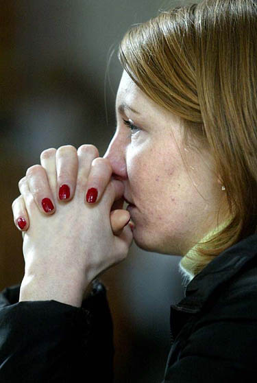 An unidentified woman prays for the Polish born Pope in a church in central Warsaw on April 1. 
