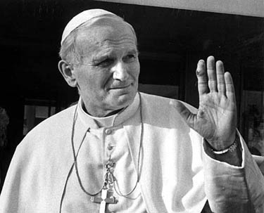 Pope John Paul ll raises his injured left hand in greetings as he leaves the Gemelli hospital, on June 3, 1981