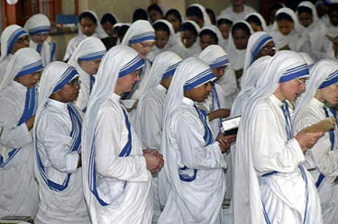 Catholic nuns from the Missionaries of Charity pray during a morning prayer for the quick recovery of Pope John Paul II in Kolkata on April 2, when Roman Catholics around the world waited and prayed as Pope John Paul slid toward death on Saturday. 