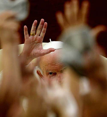 Pope John Paul II waves during his weekly Sunday Angelus at his summer retreat in Castelgandolfo, Italy on July 27, 2003.