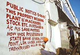 A public notice being painted on the wall of Saini Motors premises at Sherpur Chowk by the State Bank of India