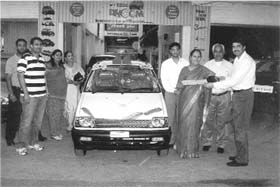 Prabha Mehta receives a key to a Maruti 800 from officials of Joshi Auto Zone at Lake Club in Chandigarh