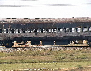 The burnt out compartments of the Howrah-bound Toofan Express stands sill near Dildarnagar on Monday