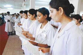 The nursing graduates of the college of nursing at CMCH take the oath at the lamp lighting ceremony in Ludhiana on Monday