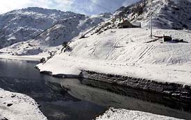 A view of the snow clad mountains at Tsomgo lake near Nathula pass in Sikkim on Monday