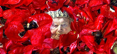 A portrait of the late Pope John Paul II is covered with rose petals before a mass at a church in Amman on Sunday
