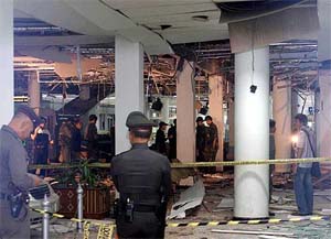 Thai police officers examine the site where a bomb exploded at a department store on Sunday night in Hat Yai town of Songkhla province, southern Thailand
