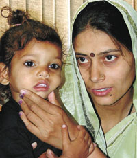 The rescued child, Love, with his mother at a press conference in the Capital