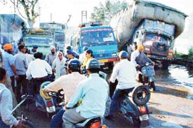 Traffic snarl at Gill village on Monday following the washing away of a road