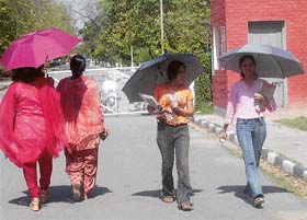 Punjabi University girls carry umbrellas for protecting themselves from Sun on university campus in Patiala