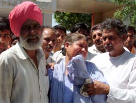 Jaswinder Singh’s family members wail at the cremation ground in Bathinda