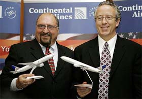 Continental Vice-President for Europe, Middle-East and Africa Jim Summerford and Continental Airlines Managing Director of sales and marketing Tim Kennedy pose with miniature models of an aircraft
