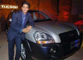 Shah Rukh Khan stands in front of Hyundais new Tucson SUV during its unveiling in New Delhi