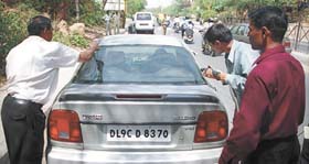 Personnel from the Forensic Department inspecting the car in which the general manager was found dead in the Capital