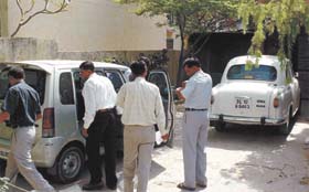 CBI officers inspecting the car of IPS officer A. A. Farooqi during a countrywide raid on many government officials in the Capital