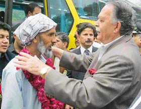 The Prime Minister of occupied Kashmir, Sardar Sikandar Hayat Khan, greets an Indian Kashmiri on arrival at Chakothi, on the Line of Control, about 58 km south of Muzaffarabad