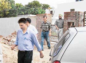 CBI officials coming out of former Haryana Chief Minister Om Prakash Chautalas residence in Chandigarh after conducting a raid