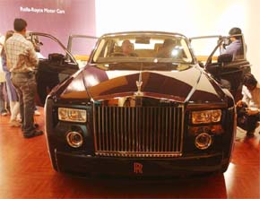 Cameramen capture Rolls-Royce sports vehicle during the launch of the car in Mumbai on Friday. Rolls-Royce car has been relaunched in India under the new model, Phantom, after 50 years with the first car to be delivered in Pune tomorrow. The car will cost Rs 4 crore, including taxes, in India. 