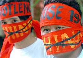 Tibetans cover their faces in Bangalore on Friday as they protest against the forthcoming visit of Chinese Prime Minister Wen Jiabao.  