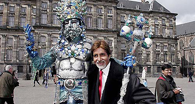 Bollywood actor Amitabh Bachchan poses with a living statue at Dam Square in the centre of Amsterdam on Friday