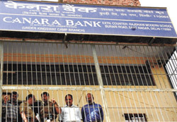 Police personnel investigating the loot case at Canara Bank in the Capital on Saturday. 